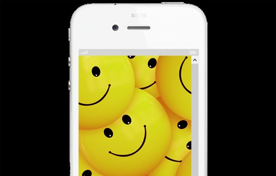 iPhone with smiley faces on display.
