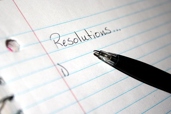 'Resolutions' written at the top of a notepad.