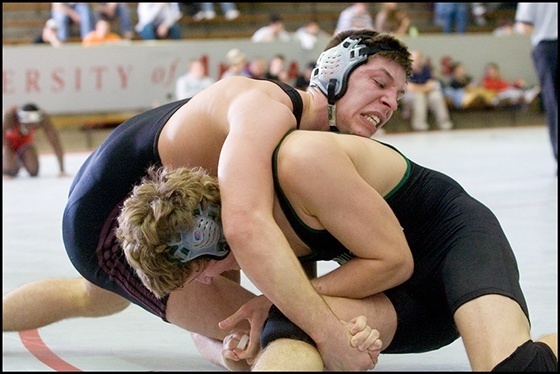 Two men wrestling.