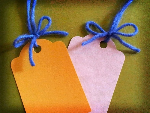 Two 'tags' made with card and wool