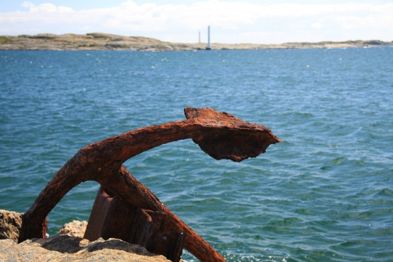 rusty anchor and sea